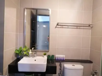 a bathroom with a sink and a mirror and a toilet at 218 Tropicana Georgetown Penang #B30 2BR for 4-7pax\u6e29\u99a8\u7a9d\u8212\u9002\u4e24\u623f in George Town