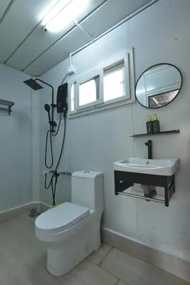 a bathroom with a toilet and a sink at AsiaCamp - Chalet Sungai Sireh in Tanjung Karang