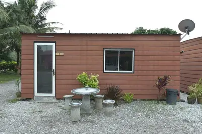 a small house with a table in front of it at AsiaCamp - Chalet Sungai Sireh in Tanjung Karang