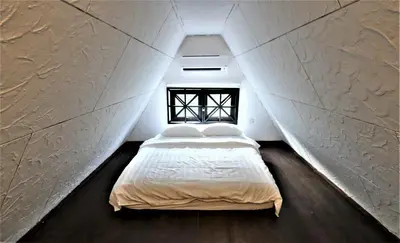 a bedroom with a large bed in a attic at The Tudor in Ipoh