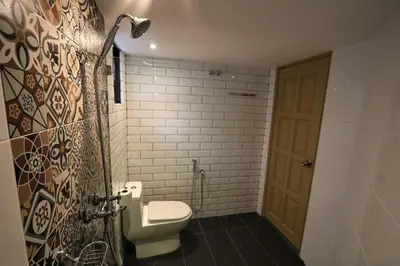 a bathroom with a white toilet and a door at The Tudor in Ipoh