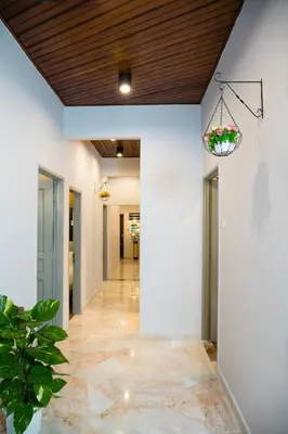 a hallway with white walls and a wood ceiling at Canning 33 in Ipoh