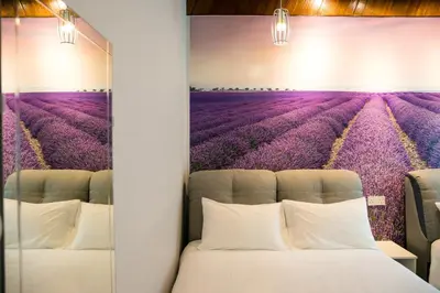 a bedroom with a lavender field mural on the wall at Canning 33 in Ipoh