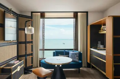 a room with a blue chair and a table and a window at The Millen Penang, Autograph Collection in George Town