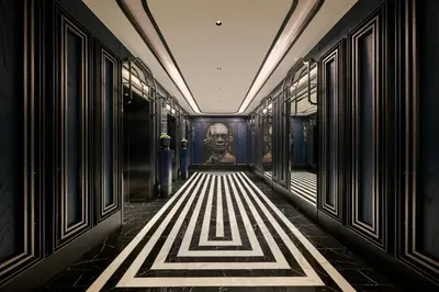 a hallway with a painting of a face on the wall at The Millen Penang, Autograph Collection in George Town