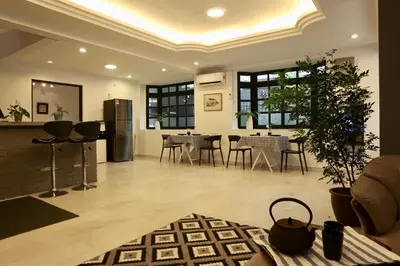 a living room with a kitchen and a dining room at G Beach Front Villa in Batu Ferringhi