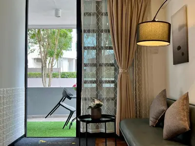 a living room with a couch and a window at G Beach Front Villa in Batu Ferringhi