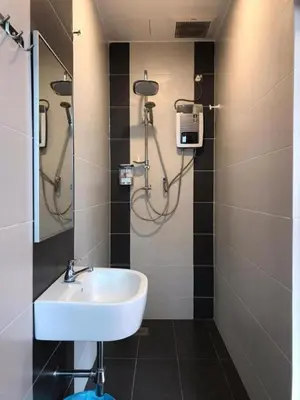 a bathroom with a sink and a shower at TT Dorf Hotel Matang in Taiping