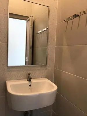 a bathroom with a white sink and a mirror at TT Dorf Hotel Matang in Taiping