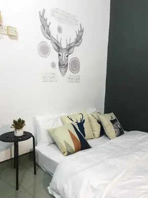 a bedroom with a bed with a deer head on the wall at The Alley's @ Sitiawan, Manjung in Sitiawan