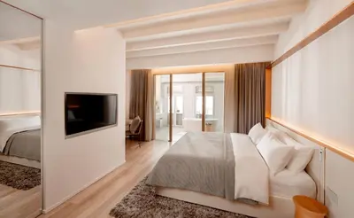 a hotel room with a bed and a television at 88 Armenian in George Town