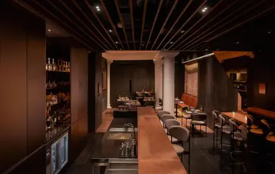 a restaurant with a long bar with stools at 88 Armenian in George Town