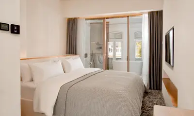a bedroom with a white bed and a window at 88 Armenian in George Town