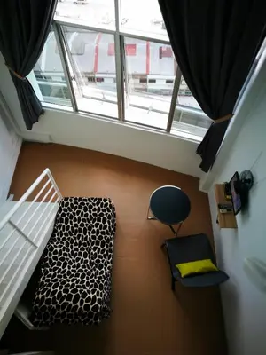 a room with a bed and a chair and a window at Comfort Zone @ The CEO Loft by Joal in George Town