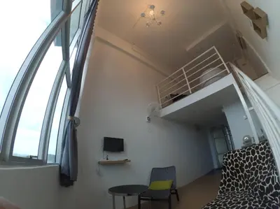 a small room with a bed and a window at Comfort Zone @ The CEO Loft by Joal in George Town