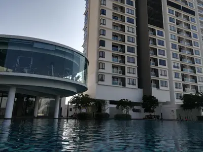 a building and a swimming pool in front of a building at Mevin Woodsbury Butterworth Homestay in Butterworth