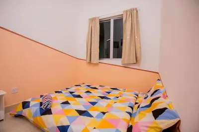 a bed in a room with a window at ICOLOR HOME & STAY CH1 in Tanah Rata