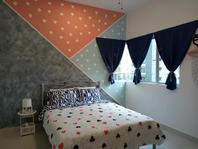 a bedroom with a bed with polka dots on it at ICOLOR HOME & STAY CH2 in Tanah Rata