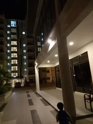 a person standing in front of a building at night at ICOLOR HOME & STAY CH2 in Tanah Rata
