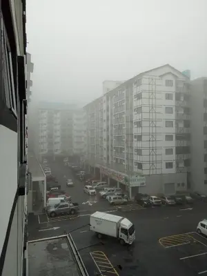 a view of a parking lot with cars and trucks at ICOLOR HOME & STAY CH2 in Tanah Rata