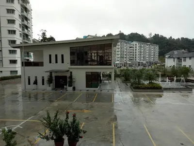 a building in a parking lot with buildings at ICOLOR HOME & STAY CH2 in Tanah Rata