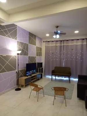 a living room with purple walls and a couch at ICOLOR HOME & STAY CH3 in Tanah Rata