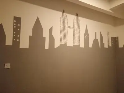 a city skyline mural on a wall in a room at ICOLOR HOME & STAY CH3 in Tanah Rata