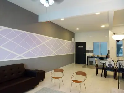 a lobby with a couch and chairs and a table at ICOLOR HOME & STAY CH3 in Tanah Rata