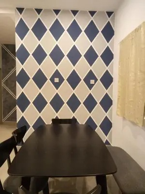 a black table and chairs in a room with blue and white tiles at ICOLOR HOME & STAY CH4 in Tanah Rata
