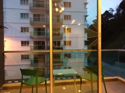 a view of a building from a window with a table and chairs at ICOLOR HOME & STAY CH4 in Tanah Rata