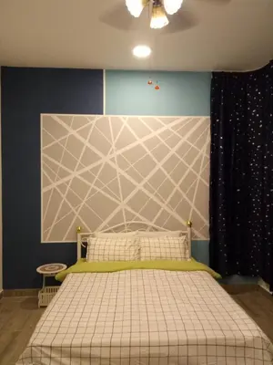 a bedroom with a bed with a green and white bedspread at ICOLOR HOME & STAY CH4 in Tanah Rata