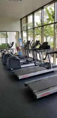 a row of cardio machines in a gym at By The Sea Beach Luxury Resort - Batu Ferringhi in Batu Ferringhi