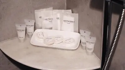 a table with a white tray and some bags on it at Artworks Hotel Ipoh in Ipoh
