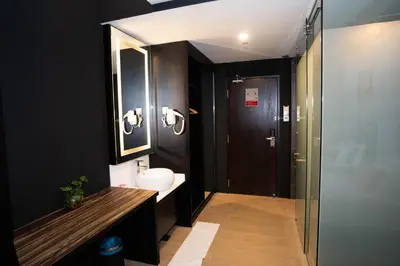 a bathroom with a sink and a toilet and a mirror at Artworks Hotel Ipoh in Ipoh