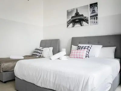 a bedroom with two beds and a couch at Casita 22, 218 Macalister Georgetown City & Seaview in George Town