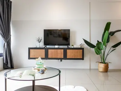 a living room with a tv and a glass table at Casita 22, 218 Macalister Georgetown City & Seaview in George Town