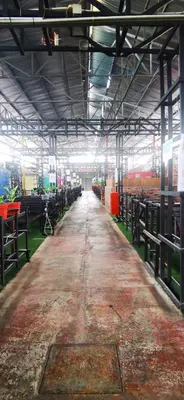 an inside view of a barn with cows at Rick Resort Teluk Intan in Teluk Intan