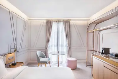 a room with a bed and a table and a chair at The Prestige Hotel Penang, a Member of Design Hotels in George Town