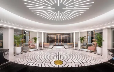a lobby with chairs and a large ceiling at The Prestige Hotel Penang, a Member of Design Hotels in George Town