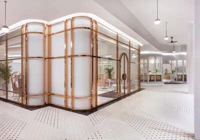a gold and white room with a glass wall at The Prestige Hotel Penang, a Member of Design Hotels in George Town