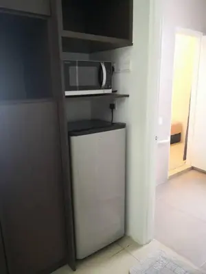 a kitchen with a microwave and a small refrigerator at My Homestay S1311 - Golden Hills Night Market in Cameron Highlands
