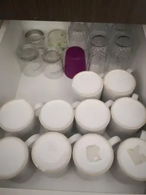 a drawer filled with white cups and other items at My Homestay S1311 - Golden Hills Night Market in Cameron Highlands