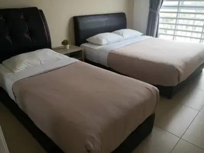 two beds in a hotel room with at My Homestay S1311 - Golden Hills Night Market in Cameron Highlands