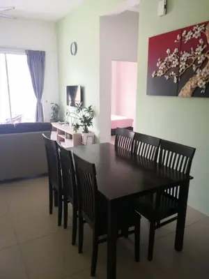 a dining table and chairs in a living room at My Homestay S1311 - Golden Hills Night Market in Cameron Highlands
