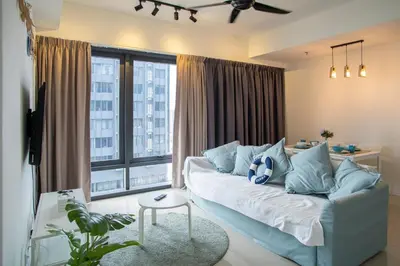 a living room with a couch and a large window at Tropicana 218 MACALISTER in George Town
