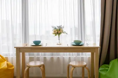 a table with two chairs and a vase of flowers at Tropicana 218 MACALISTER in George Town