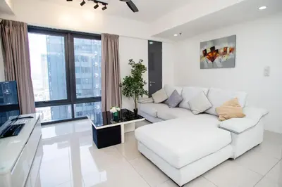 a white living room with a couch and a table at Tropicana 218 MACALISTER in George Town