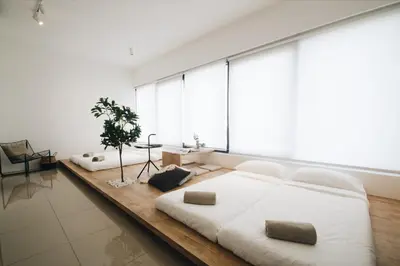a large white bed in a room with a large window at Tropicana 218 MACALISTER in George Town