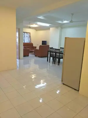 a living room with a couch and a table at Desair Apartment By SCHT in Lumut