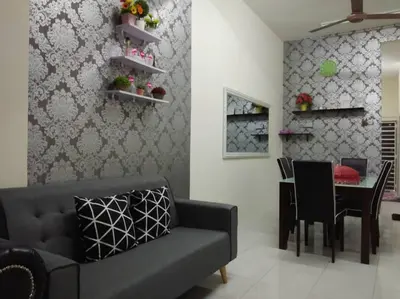 a living room with a couch and a table at Zah’ra Homestay in Kuala Lipis